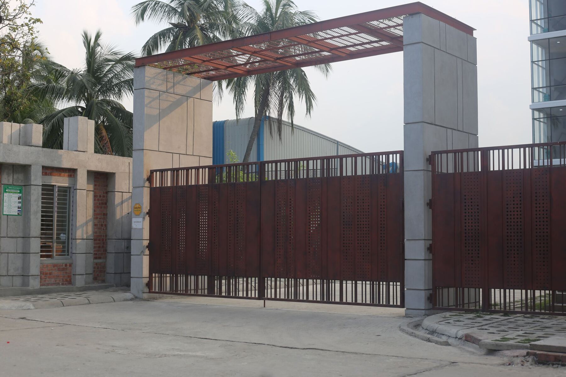 Perforated steel gates under a steel entrance canopy